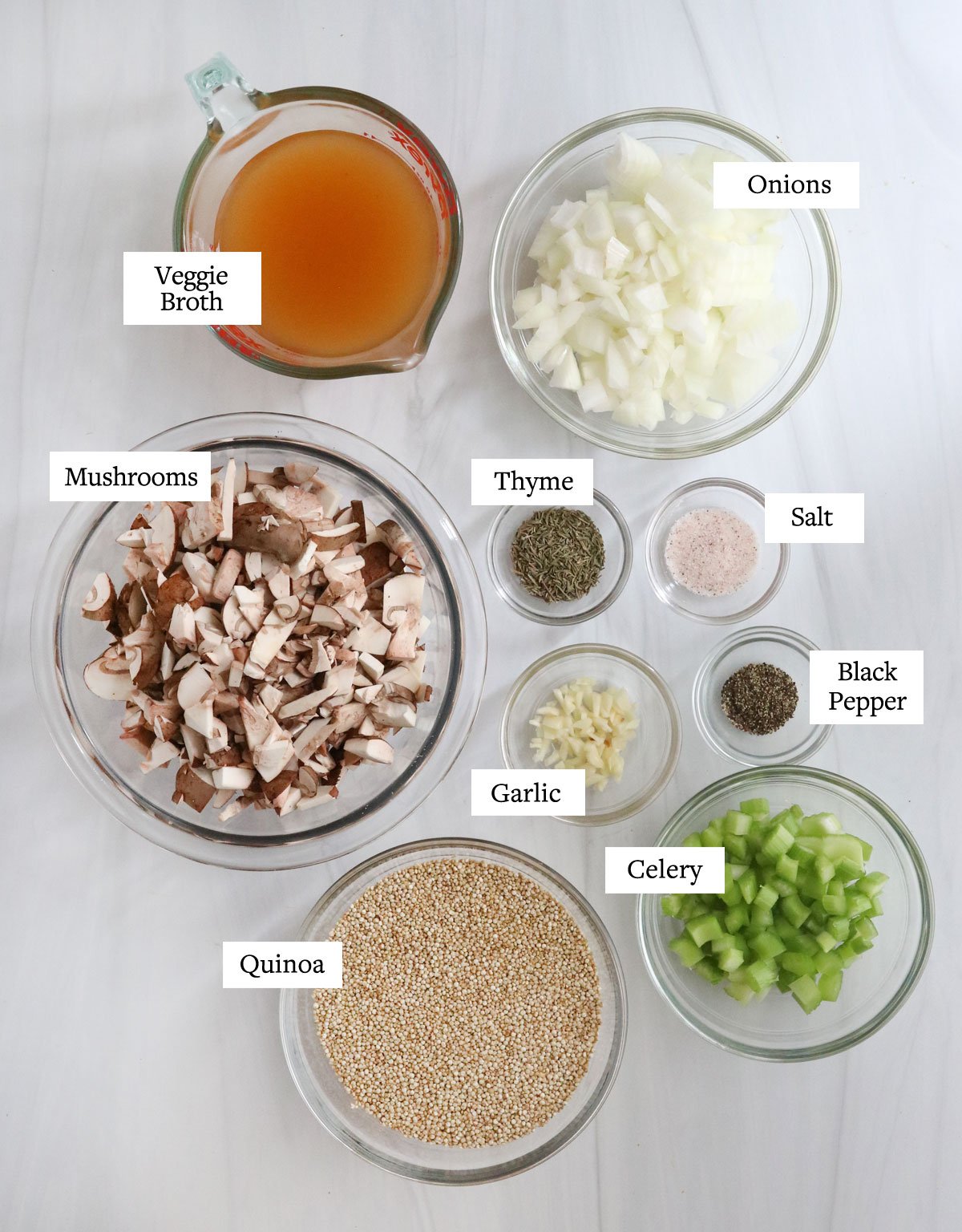 quinoa pilaf ingredients in glass bowls on white surface