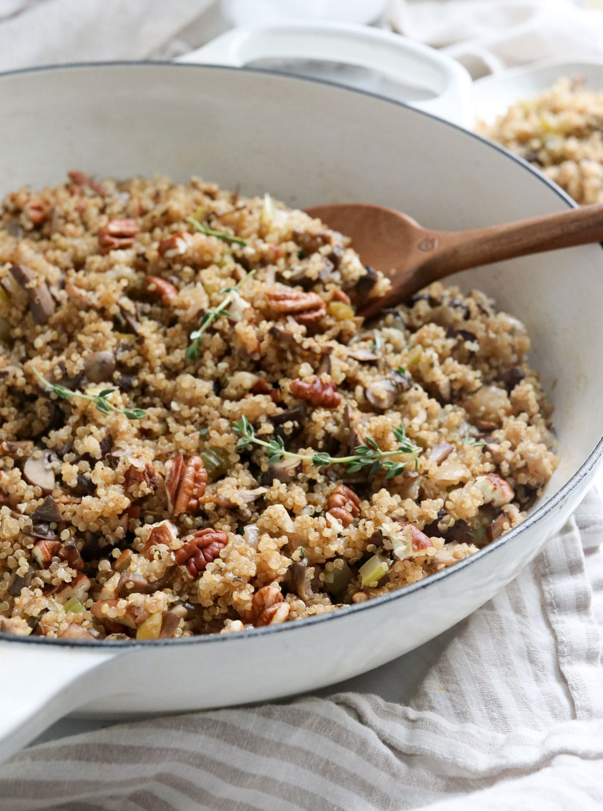 quinoa pilaf with pecans and fresh thyme in pan