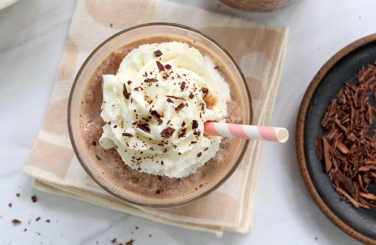 frozen hot chocolate with toppings and straw.