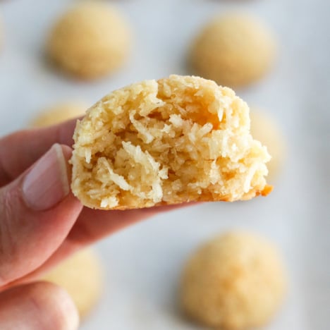 fingers holding a coconut macaroon