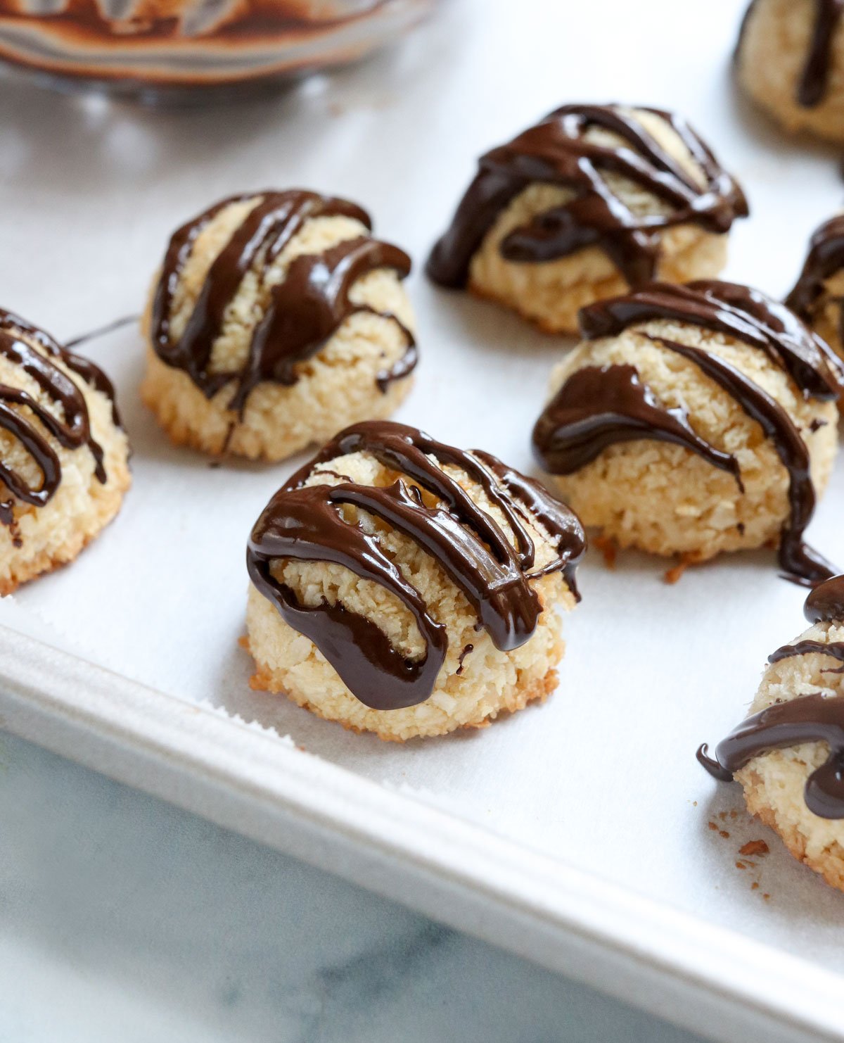 coconut macaroons on pan with chocolate