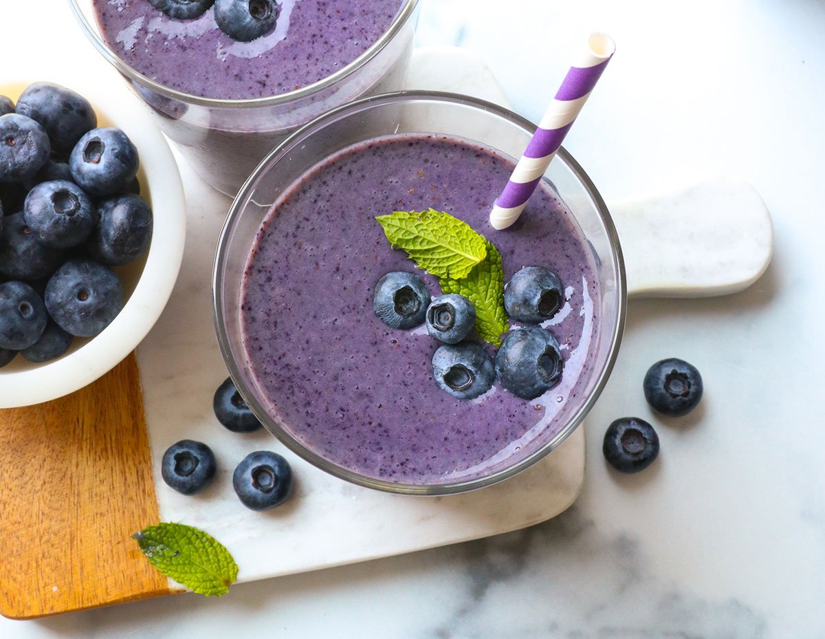 blueberry smoothie topped with mint leaves. 