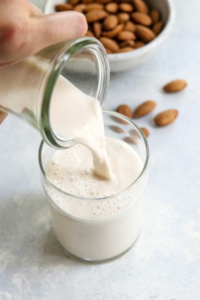 how to make almond milk recipe pouring into glass