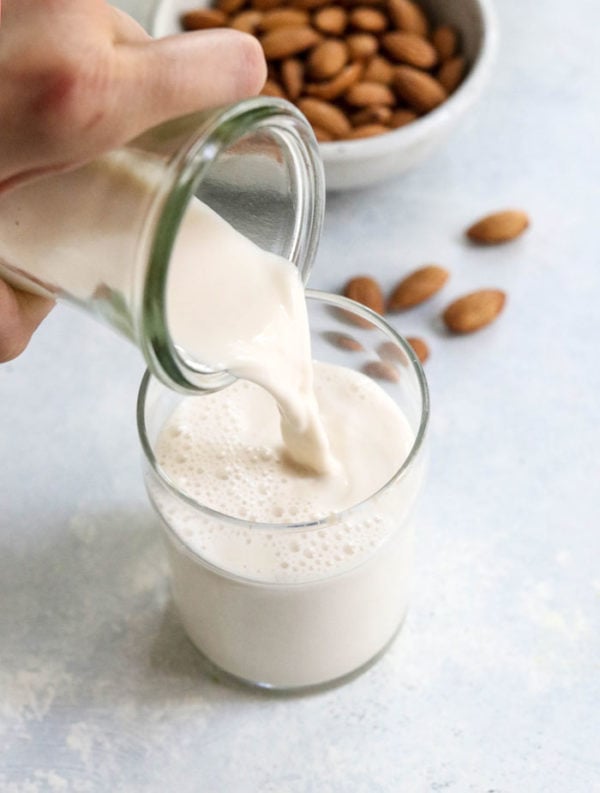 how to make almond milk recipe pouring into glass