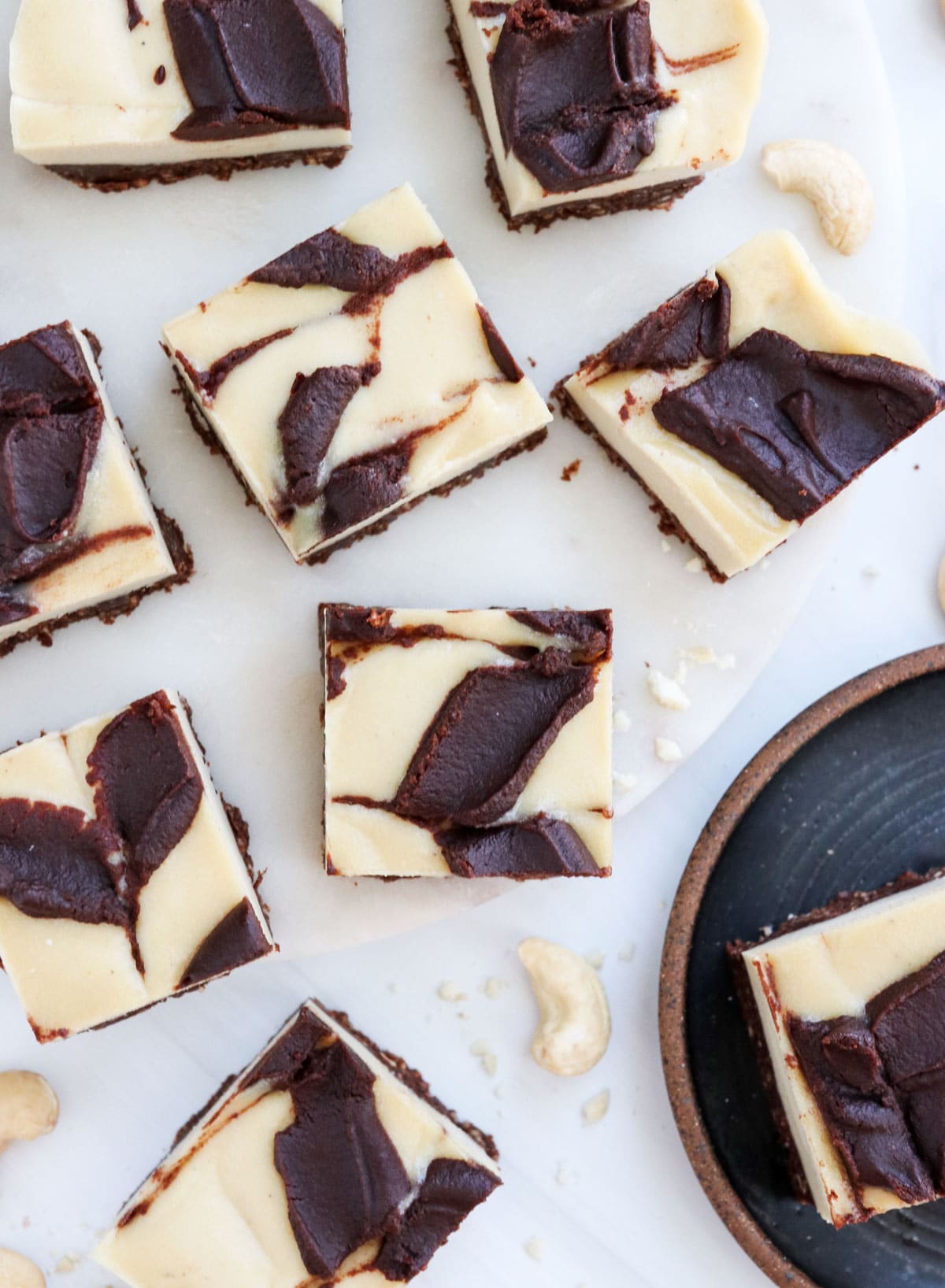 chocolate swirled cheesecake bars overhead on cutting board