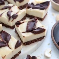 vegan chocolate cheesecake bars on white surface
