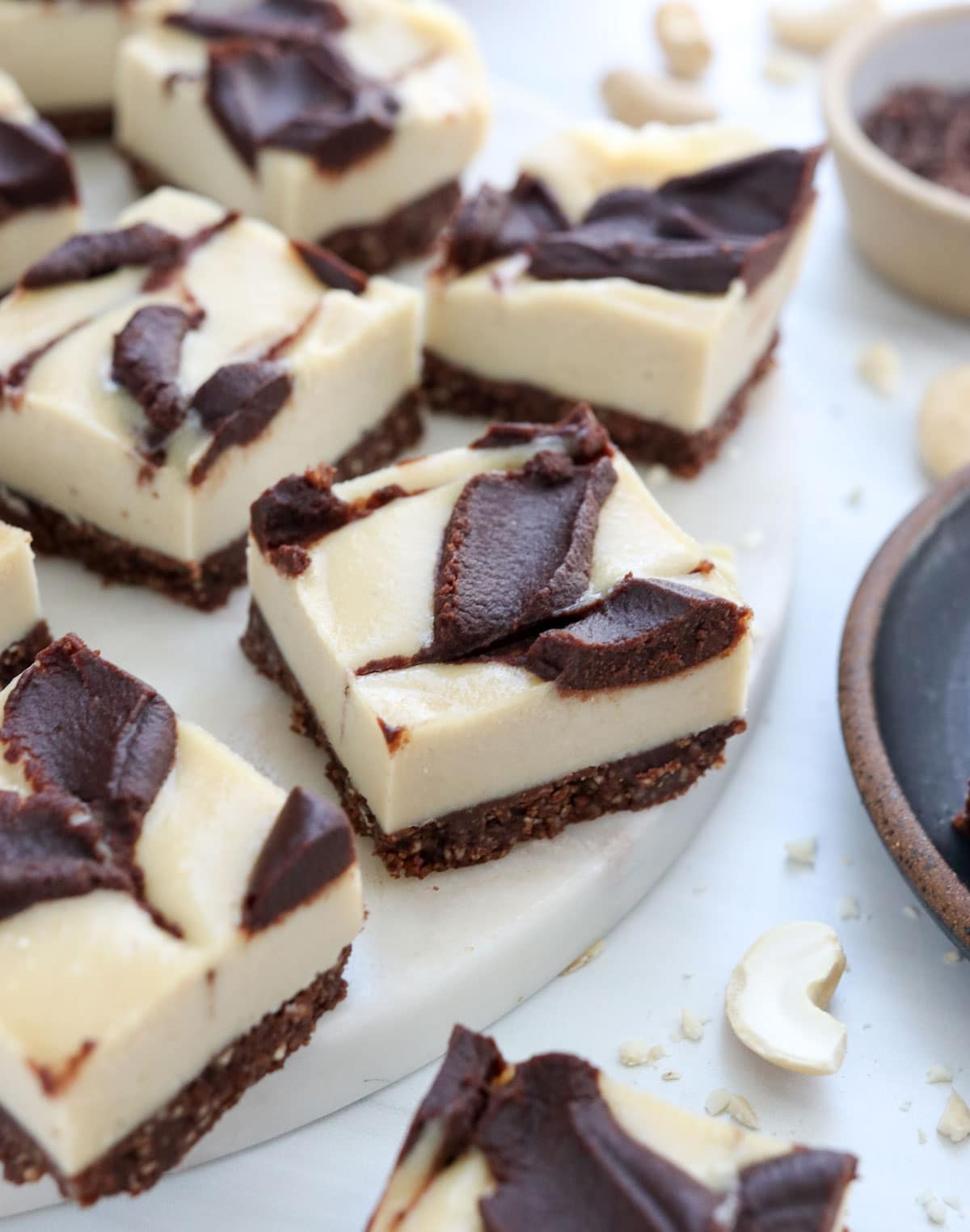 vegan chocolate cheesecake bars on white surface