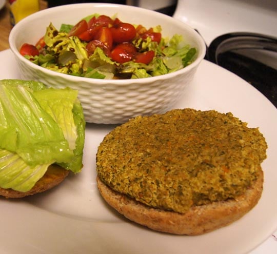 Veggie millet burger on bun with salad 