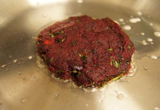 beet veggie burger in frying pan 