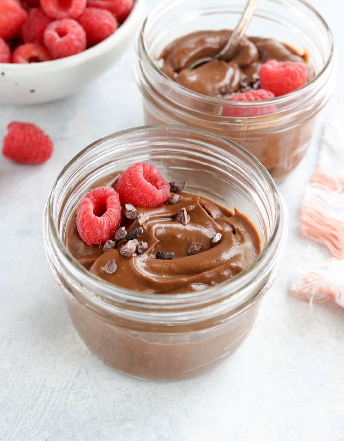 chocolate avocado pudding in two glass jars