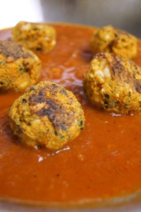 Italian meatless balls on a bed of tomato sauce