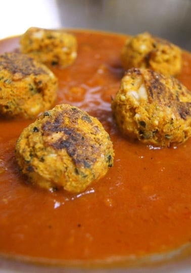 Italian meatless balls on a bed of tomato sauce