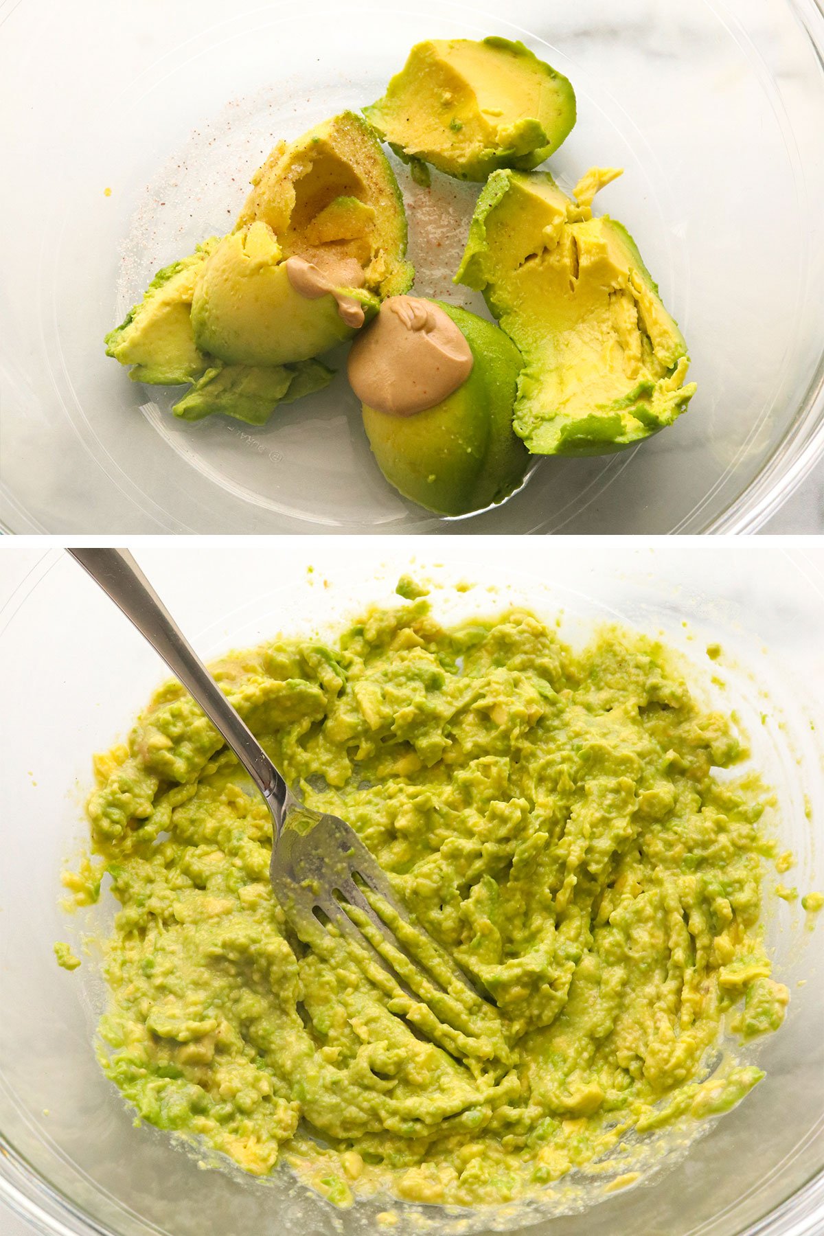 avocado mashed in a glass bowl for egg salad.