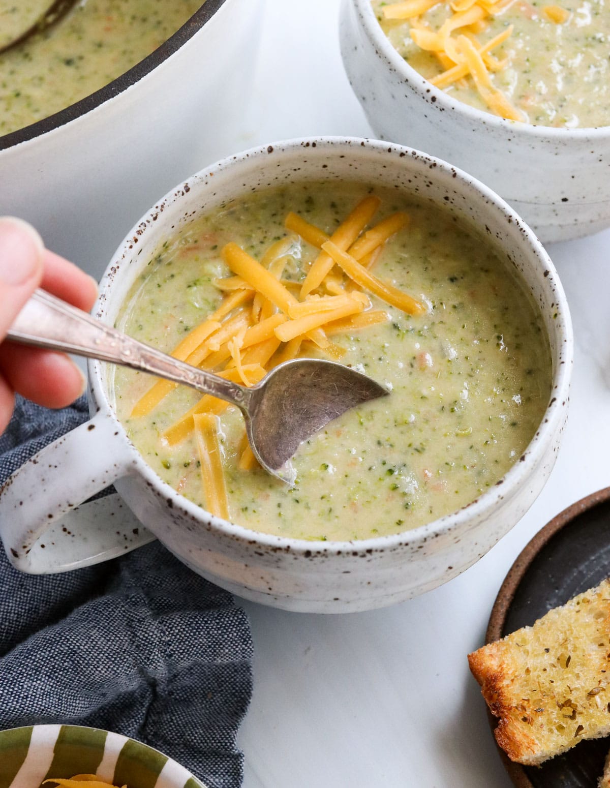 soup going into bowl of broccoli cheddar soup.