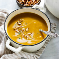curried butternut squash soup with seeds on top.