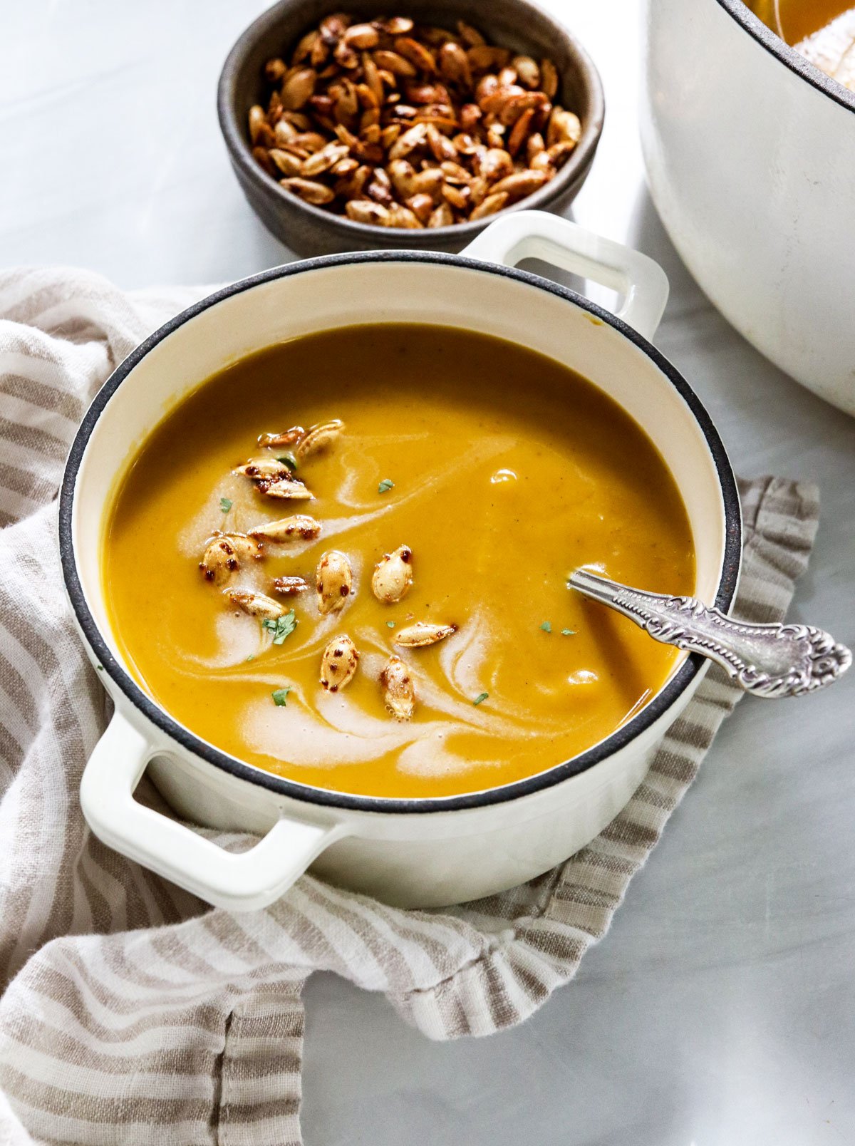 curried butternut squash soup with seeds on top.