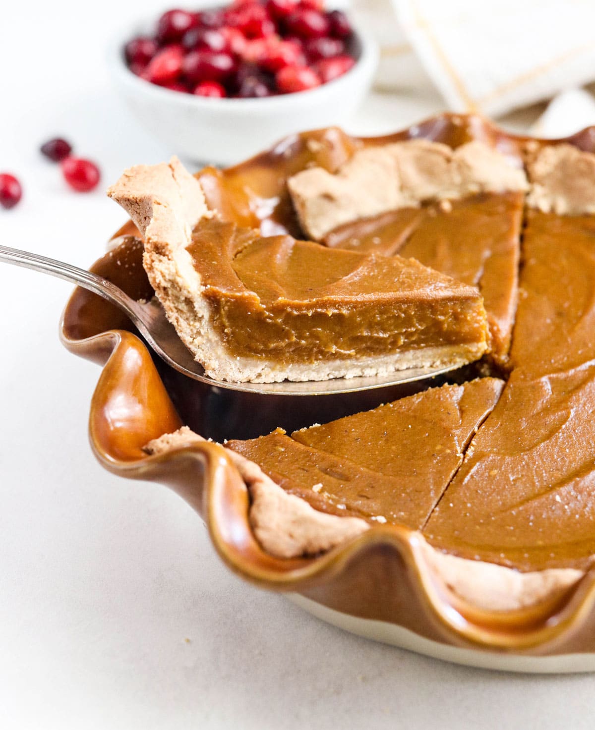 slice of vegan pumpkin pie being served