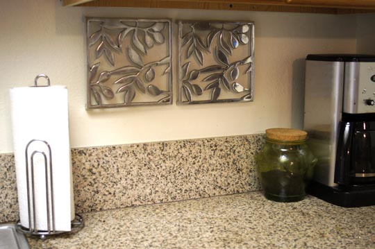 coffee maker, jar, and paper towels on the counter