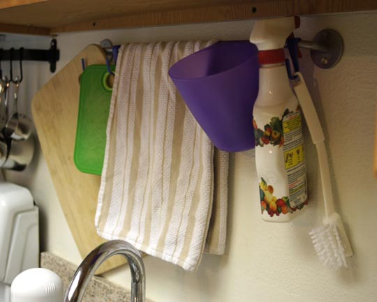 towels and scub brush hanging on a rack