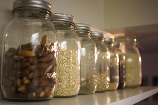 mason jars filled with nuts, grains, and berries