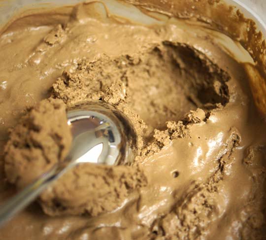 scooping chocolate mousse with a spoon