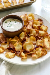 parsnip chips on plate with ranch dip.
