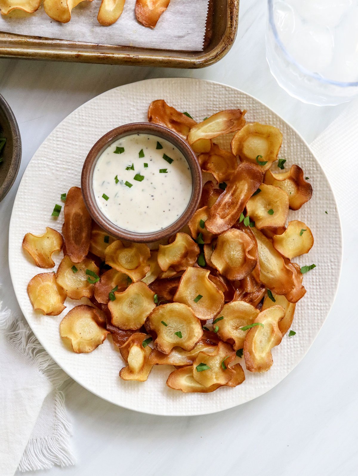 parsnip chips on serving plate with dip.