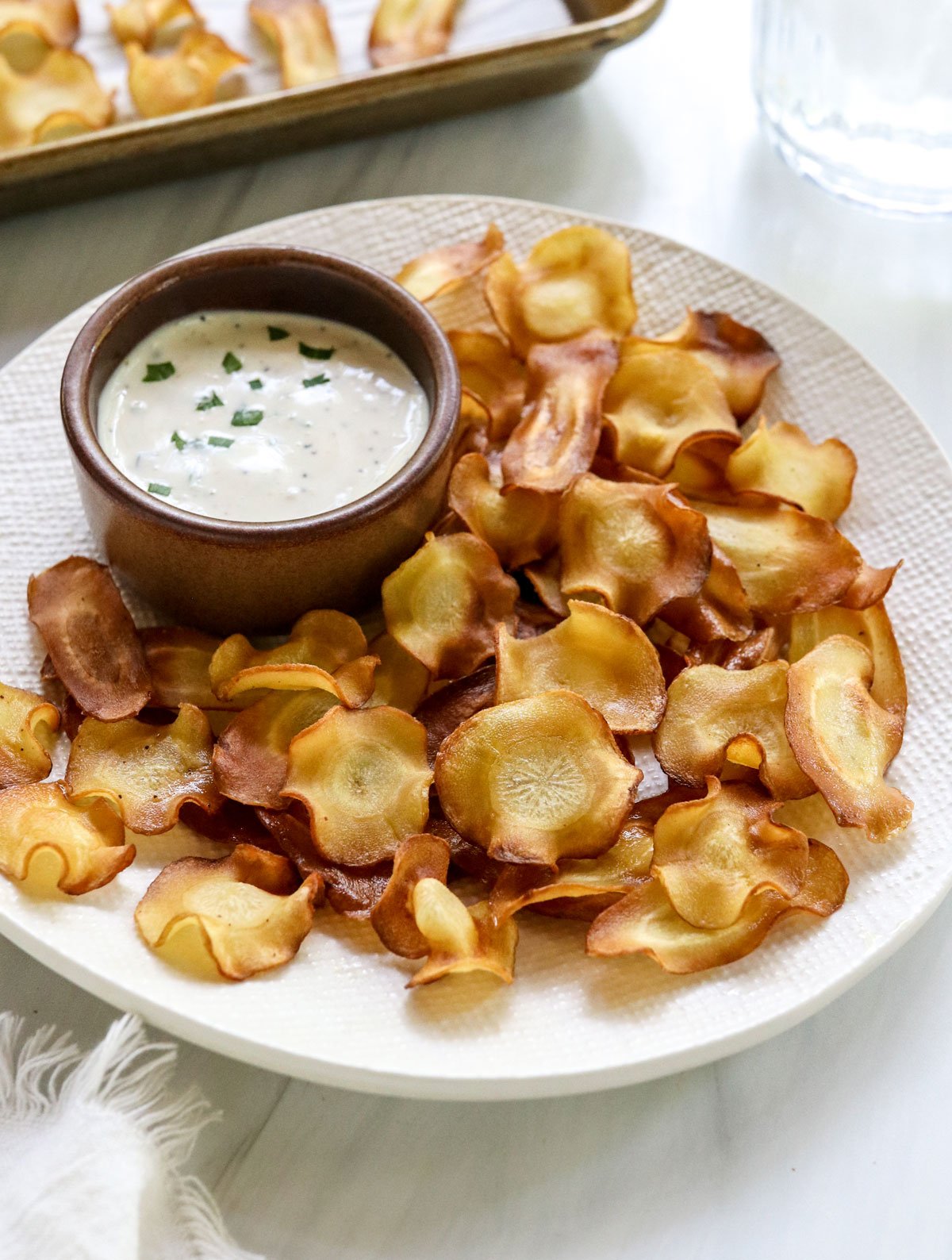 parsnip chips on plate with ranch dip.