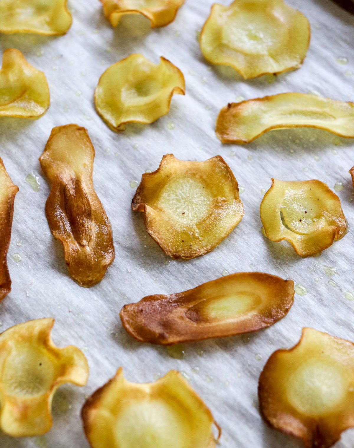 closeup of parsnip chips on pan.