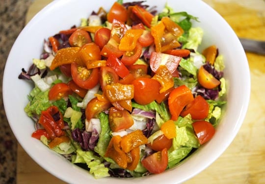 salad in a bowl with tomato slices on top