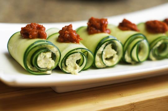 rolled cucumber slices with sun dried tomatoes on top