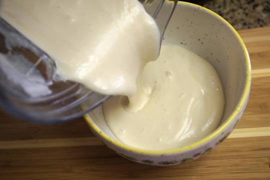 pouring frosting into a bowl