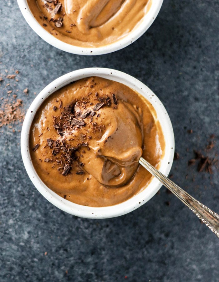 bowl of chocolate avocado pudding with chocolate shavings on top