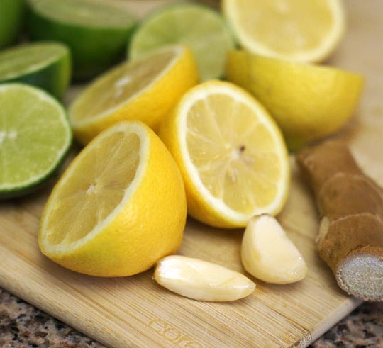 lemon and lime halves on a cutting board