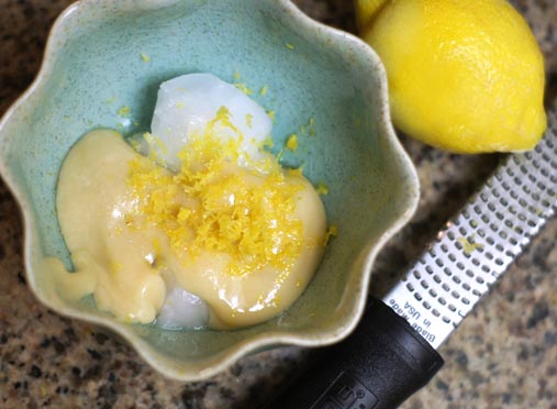 lemon frosting ingredients in a small blue bowl