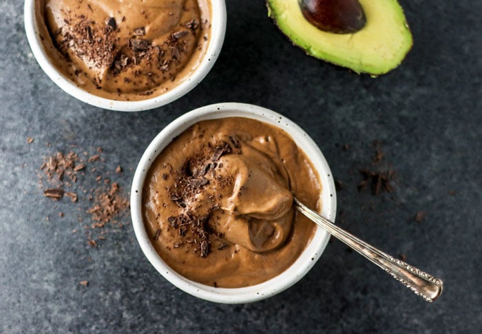 bowl of chocolate avocado pudding with chocolate shavings on top