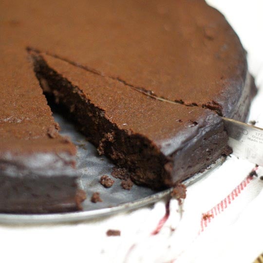 flourless chocolate cake being cut