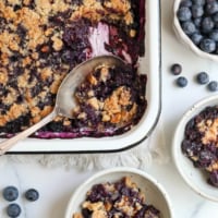 blueberry crisp served from pan into bowls