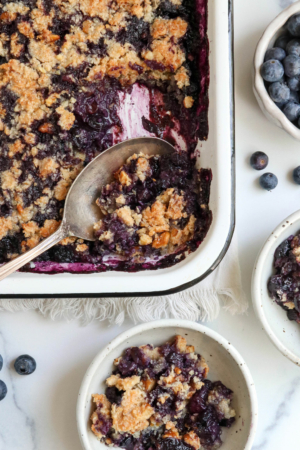 blueberry crisp served from pan into bowls