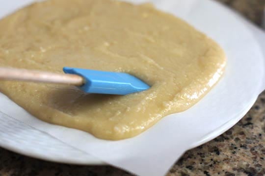 spreading macadamia nut fudge batter with a spatula