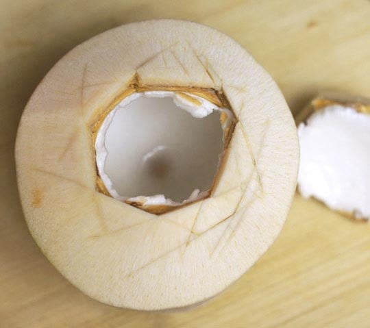 coconut with a hole cut out of the top