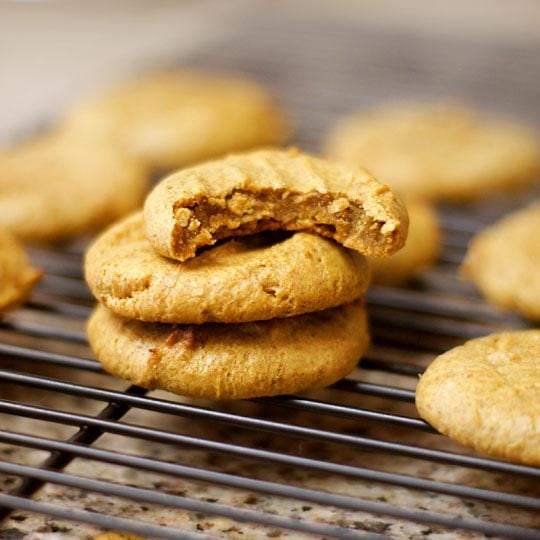 pumpkin pie cookies on a cooling rack with a bite out of one cookie