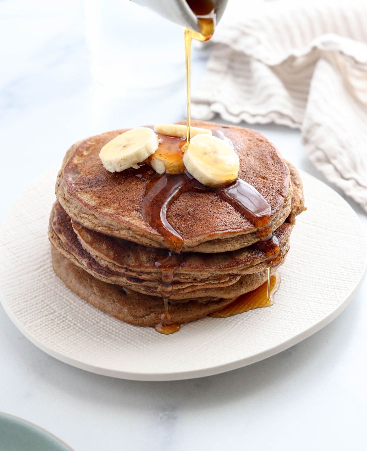 paleo pancakes with banana slices on top