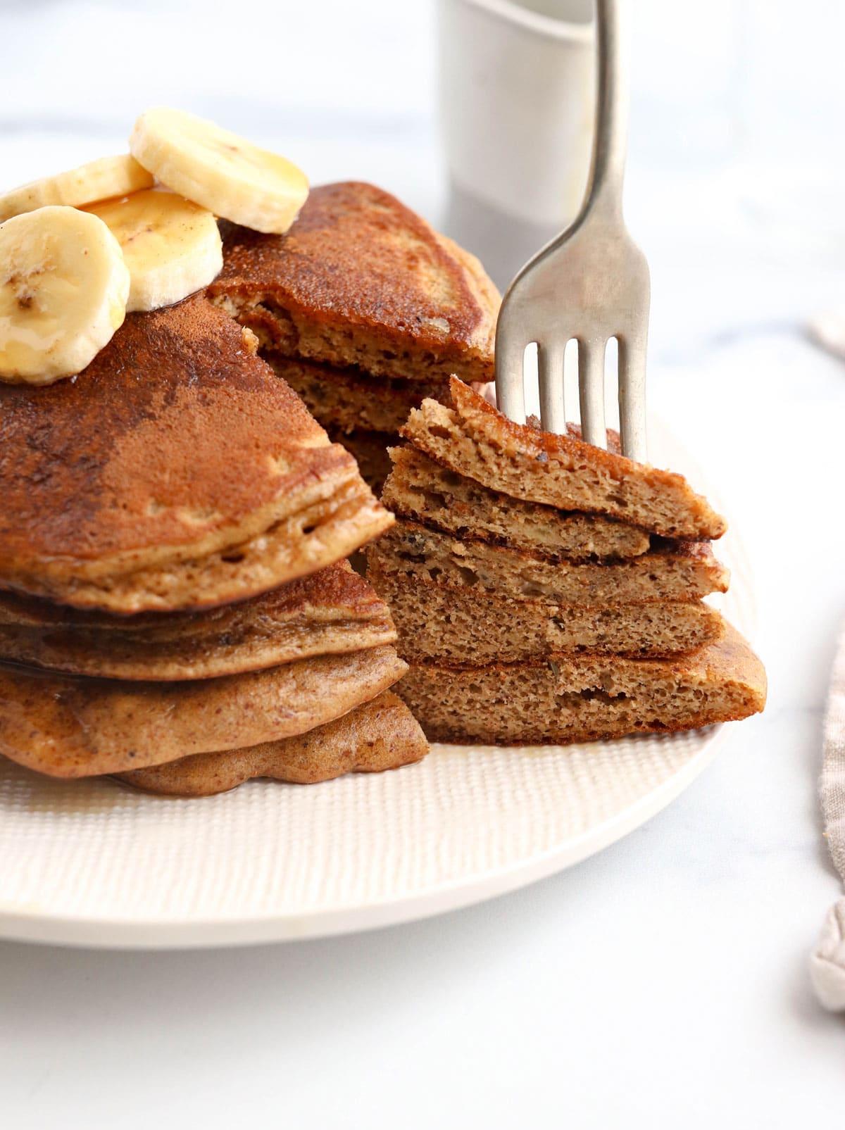 fork in a stack of paleo pancakes