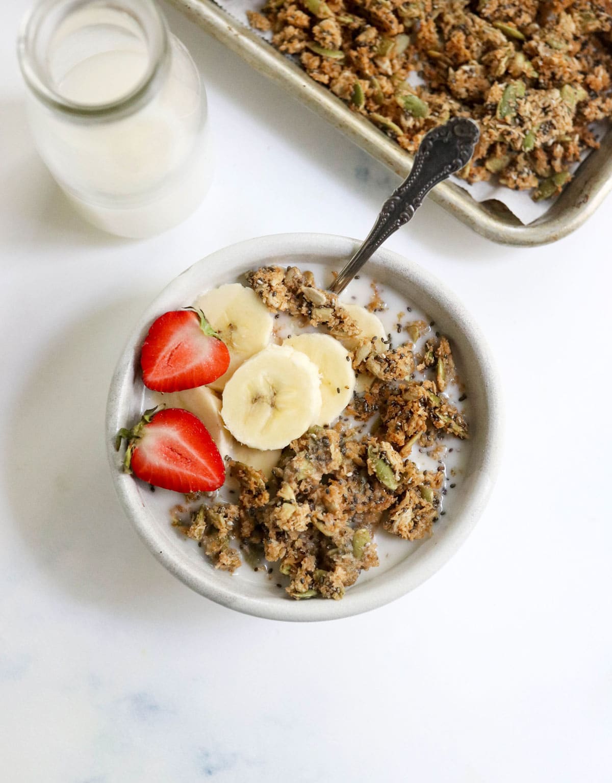 pumpkin seed granola in bowl with fruit on top