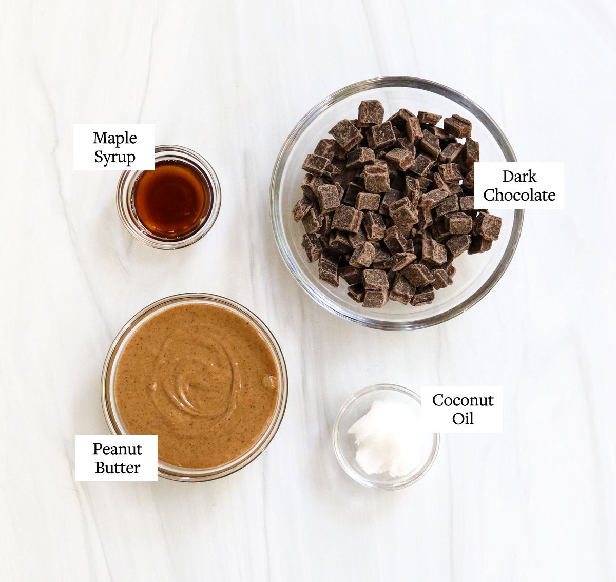 peanut butter cup ingredients labeled in glass bowls.