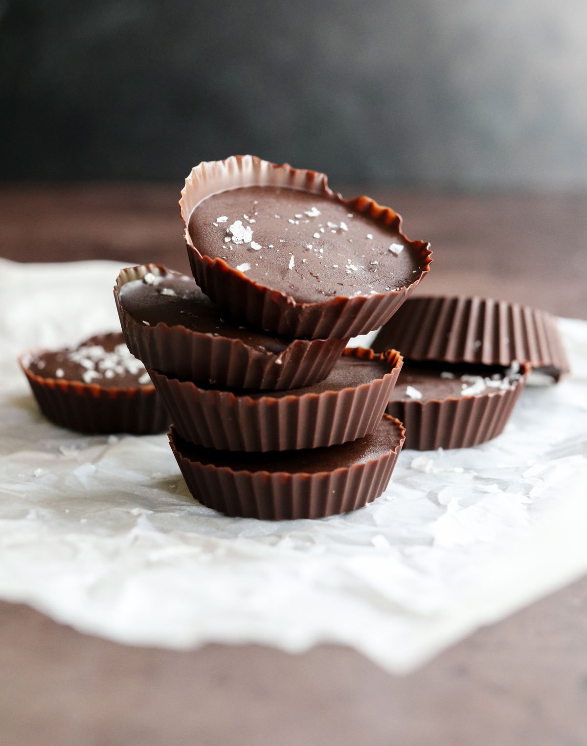 peanut butter cups stacked with flaky sea salt on top.