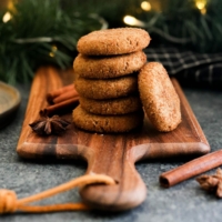 vegan ginger cookies stacked on board