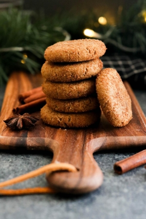 vegan ginger cookies stacked on board