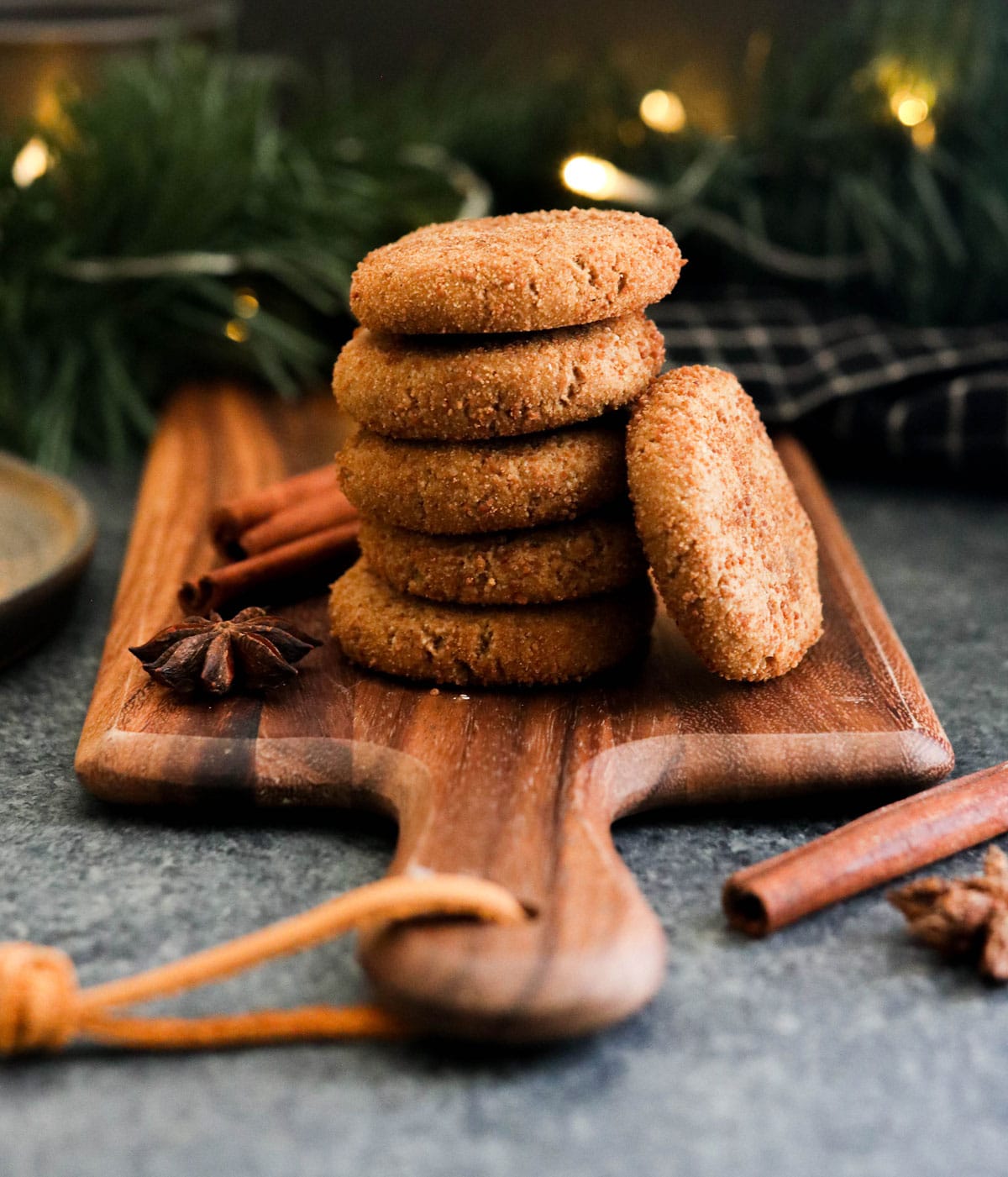 vegan ginger cookies stacked on board